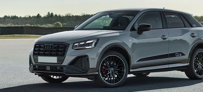 Audi Q2 on a broad parking with a forest