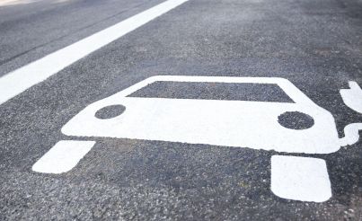 Symbol of an electric car on a road